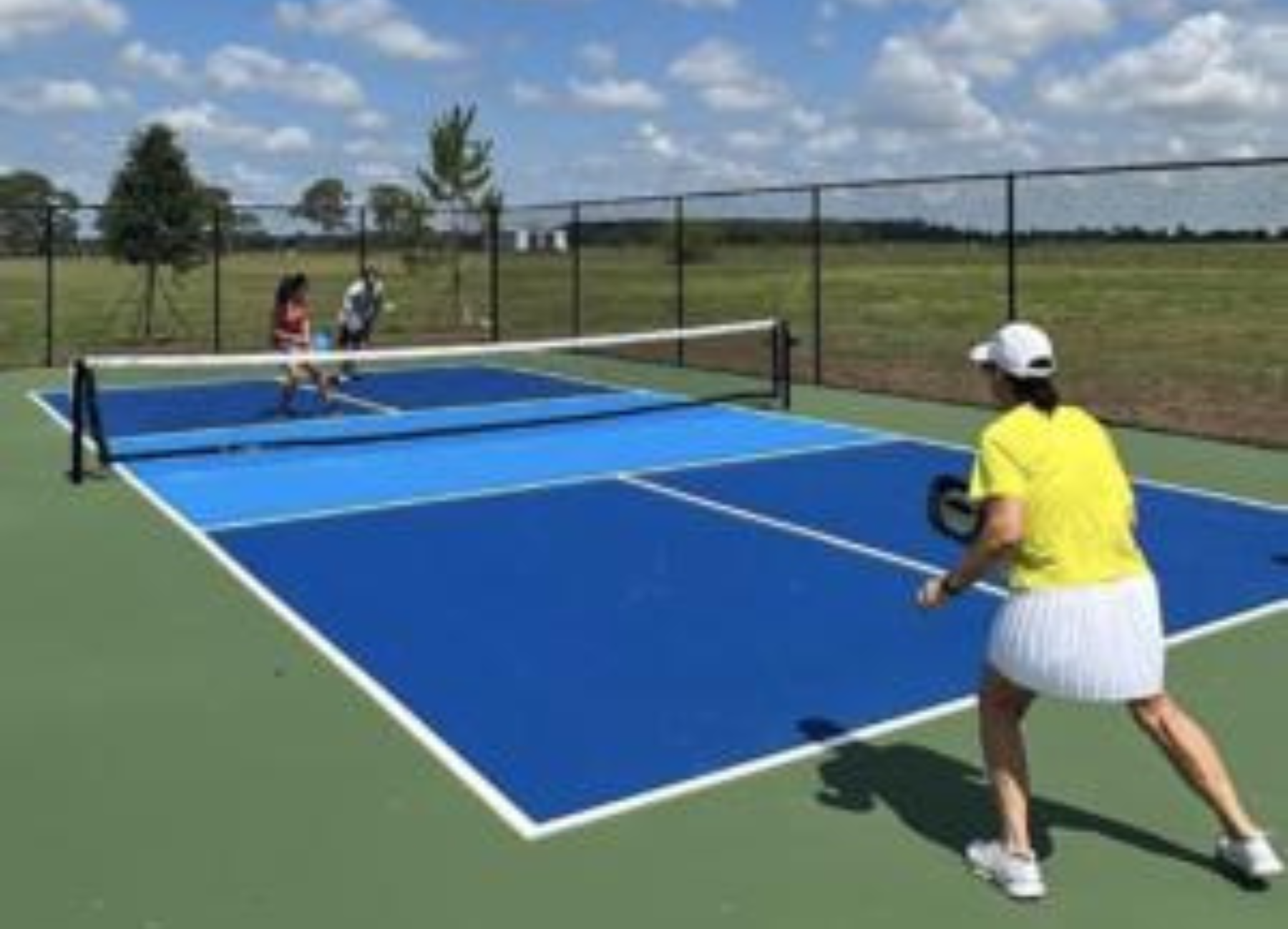 three-pickleball-players-on-a-pickleball-court-OK-Corral-Gun-Club-Okeechobee-open-to-the-public